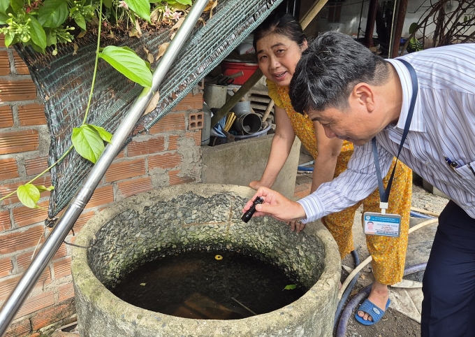 20250715-090335-1754834473-175-3408-9360-1754834631 Cán bộ ngành y tế TP HCM soi đèn tìm loăng quăng ở các vật dụng chứa nước tại nhà dân khi giám sát phòng chống dịch ở Củ Chi, hồi tháng 7. Ảnh: Lê Phương